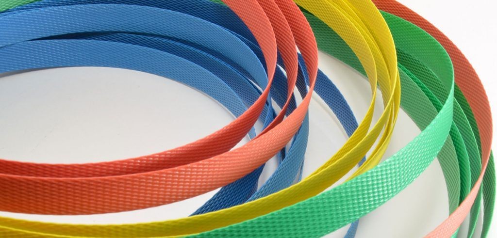 Various bands of colorful pallet strapping in different colors.