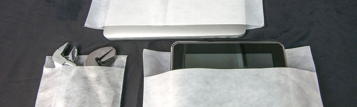 Nonwoven spunbond material pouches containing tools, a laptop, and a tablet.