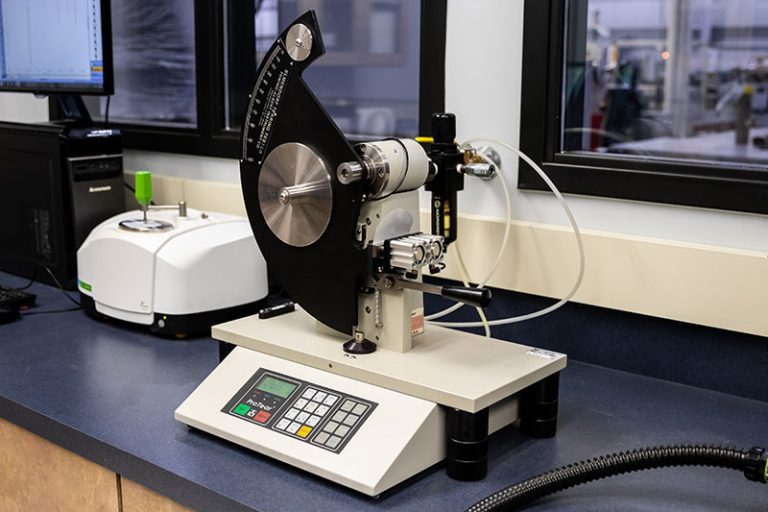 Elmendorf tear testing equipment used to measure the tear resistance of packaging materials for durability and strength.
